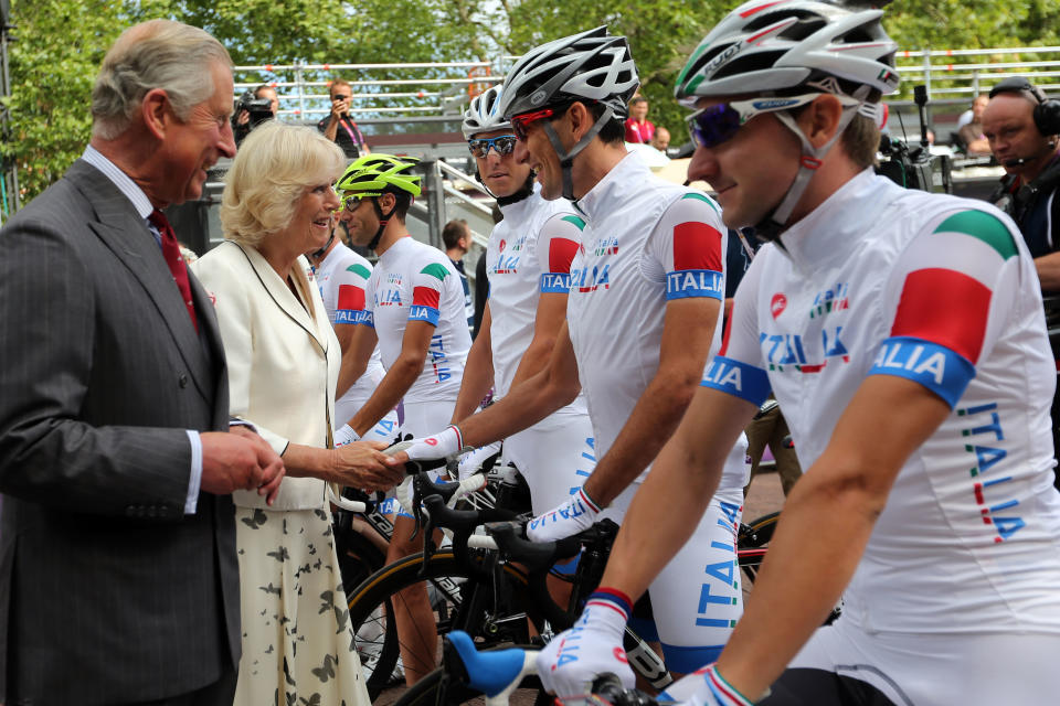 LONDON, ENGLAND - JULY 28: Camilla, Duchess of Cornwall (L) and Prince Charles, Prince of Wales speak with the Italy team ahead of the Men's Road Race Road Cycling on day 1 of the London 2012 Olympic Games on July 28, 2012 in London, England. (Photo by Bryn Lennon/Getty Images)