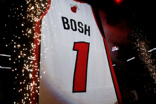 Former Miami Heat player Chris Bosh's jersey is raised to the rafters during his jersey retirement ceremony at halftime of the game between the Miami Heat and the Orlando Magic