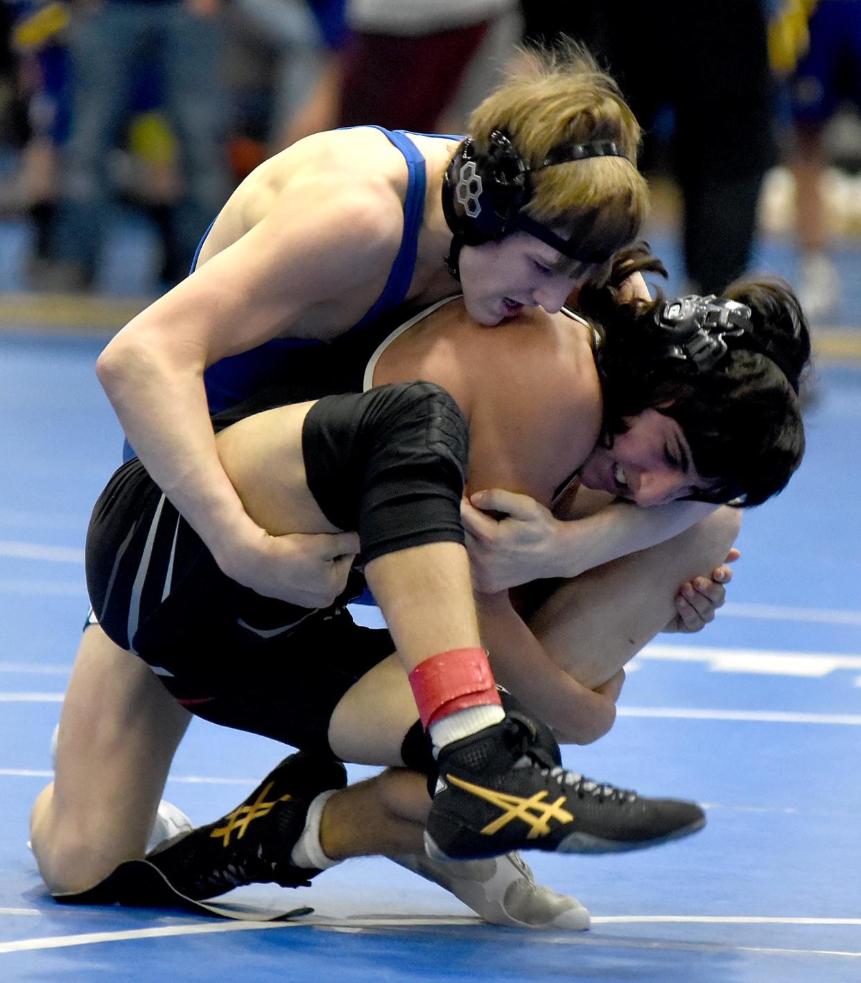 Kade Kluce of Dundee ties up Dylan Spencer of Milan on the way to a pin in the 112 pound finals of the Division 3 Individual District at Dundee Saturday.