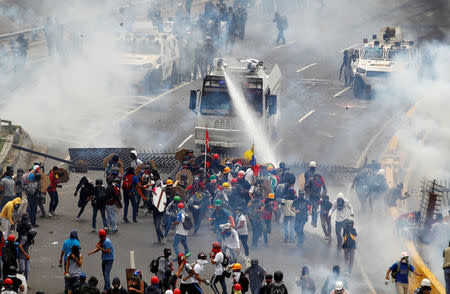 Opposition supporters clash with riot police during a rally against President Nicolas Maduro in Caracas, Venezuela, May 3, 2017. REUTERS/Christian Veron