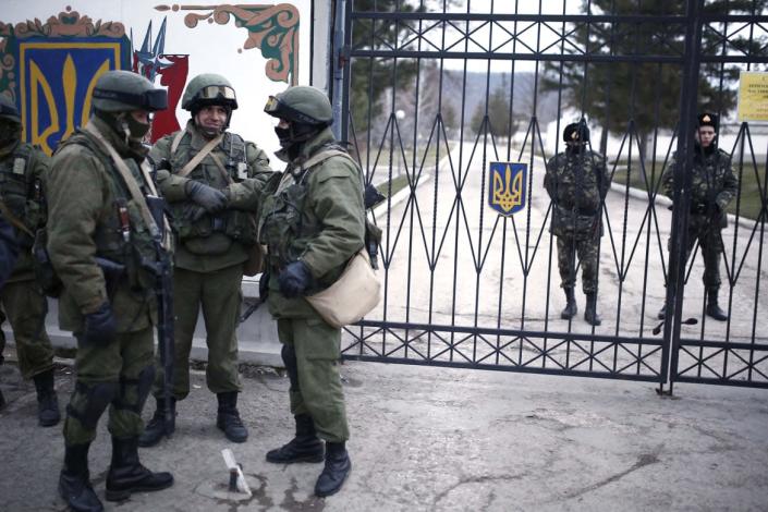 <div class="inline-image__caption"><p>Russian armed forces stand guard around the Ukrainian military base in the village of Perevalne on March 2, 2014. Russia surrounded Ukraine’s troops in Crimea.</p></div> <div class="inline-image__credit">Anadolu Agency/Getty</div>