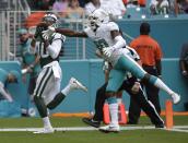 <p>New York Jets wide receiver Jermaine Kearse (10) catches a touchdown pass as Miami Dolphins cornerback Cordrea Tankersley (30) attempts to defend, during the first half of an NFL football game, Sunday, Oct. 22, 2017, in Miami Gardens, Fla. (AP Photo/Lynne Sladky) </p>