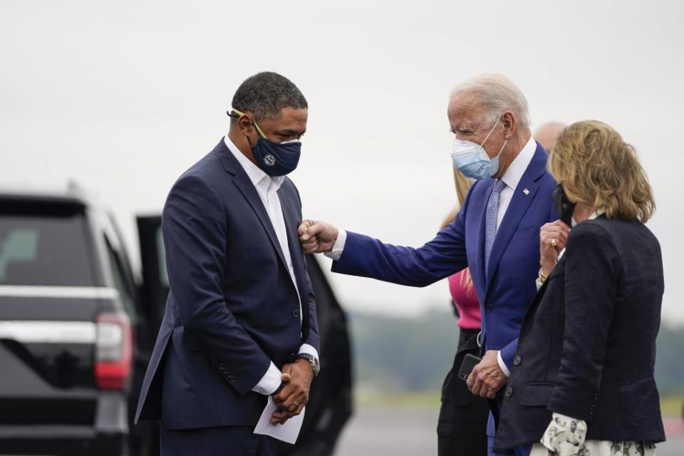 (L-R) Rep. Cedric Richmond (D-LA) and Democratic presidential nominee Joe Biden greet each other as Biden arrives at Columbus Airport on October 27, 2020 in Columbus, Georgia. (Photo by Drew Angerer/Getty Images)