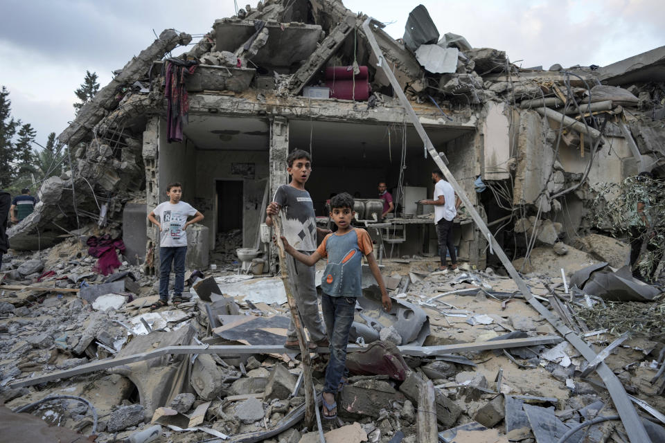 Palestinians look at the destruction after an Israeli airstrike in Deir al Balah, Gaza Strip, Tuesday, April 30, 2024. (AP Photo/Abdel Kareem Hana)