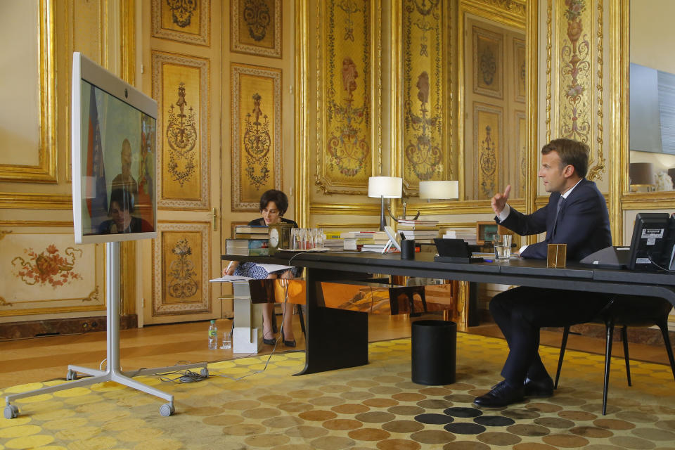 French President Emmanuel Macron talks to Russian President Vladimir Putin during a video conference Friday, June 26, 2020 at the Elysee Palace in Paris. Russian President Vladimir Putin holds video talks with French President Emmanuel Macron about the virus, Libya, Syria and relations with the U.S. under Donald Trump. (AP Photo/Michel Euler, Pool)