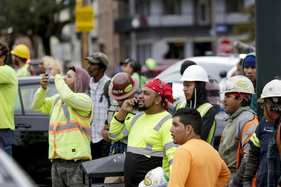Construction workers look on after a large portion of a hotel under construction suddenly collapsed in New Orleans on Saturday, Oct. 12, 2019. Several construction workers had to run to safety as the Hard Rock Hotel, which has been under construction for the last several months, came crashing down. It was not immediately clear what caused the collapse or if anyone was injured. (Scott Threlkeld/The Advocate via AP)