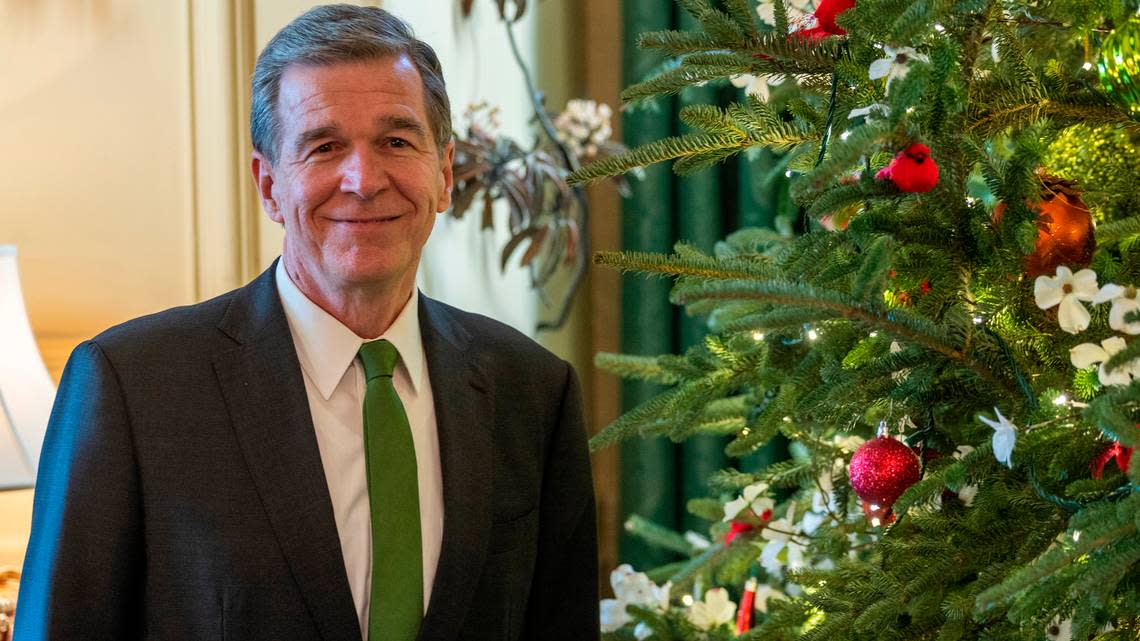 Gov. Roy Cooper with the State Christmas Tree at the Executive Mansion Monday, Dec. 16, 2022.