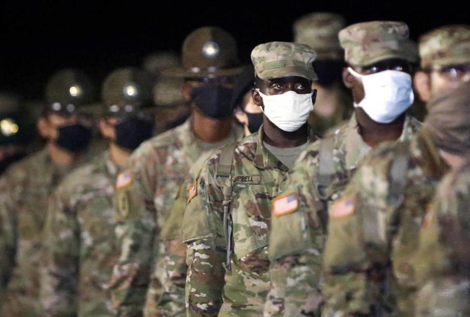 Soldiers wear face masks during the Soldier’s Ceremony at Fort Jackson. A week from finishing basic training, recruits advance to becoming soldiers and are presented the Army patch and their beret during an early morning ceremony. 9/10/20