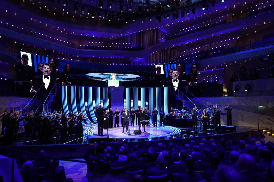 David Garrett, center right, and tenor Jonas Kaufmann, center left, perform during the draw for the UEFA Euro 2024 soccer tournament finals in Hamburg, Germany, Saturday, Dec. 2, 2023. (AP Photo/Martin Meissner)