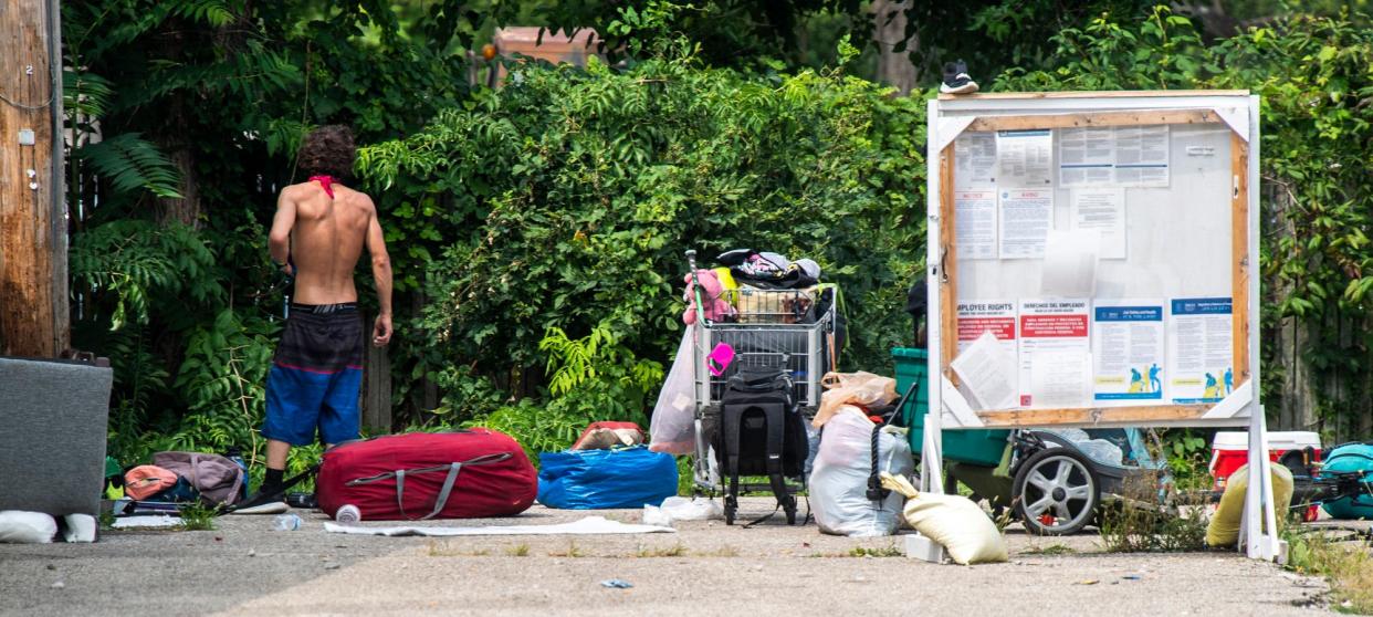 An unhoused person's belongings are spread out in a camp next to the Perry Township Trustee's office on Thursday, Aug. 24, 2023. New Leaf New Life is located in the same building.