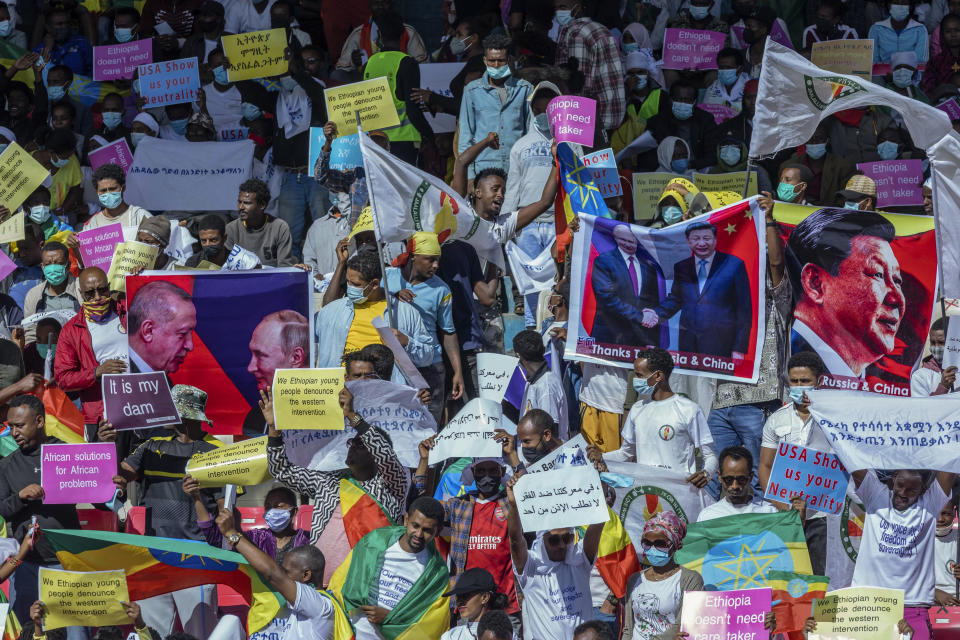 Ethiopians protest against international pressure on the government over the conflict in Tigray, at a demonstration organised by the city mayor's office held at a stadium in the capital Addis Ababa, Ethiopia Sunday, May 30, 2021. Thousands of Ethiopians gathered Sunday to protest outside pressure on the government over its brutal war in Tigray, after the U.S. said last week it has started restricting visas for government and military officials of Ethiopia and Eritrea who are seen as undermining efforts to resolve the fighting. (AP Photo/Mulugeta Ayene)