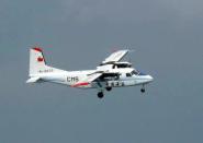 A Chinese government plane flies over international waters, 90kms north of disputed islets known as the Senkaku islands in Japan and Diaoyu islands in China, in the East China Sea, on February 21, 2014