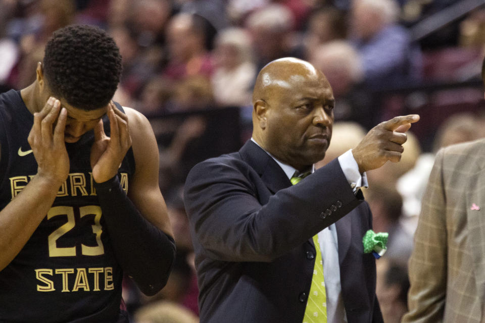 Florida State head coach Leonard Hamilton, right, calls up a player to replace injured guard M.J. Walker (23) in the first half of an NCAA college basketball game against Notre Dame in Tallahassee, Fla., Saturday, Jan. 25, 2020. (AP Photo/Mark Wallheiser)