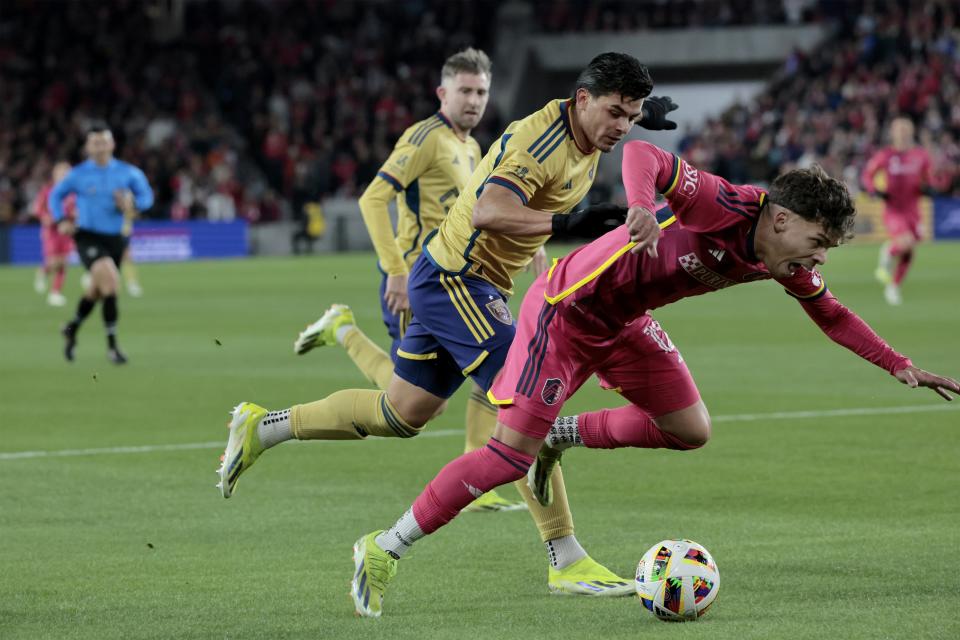 St. Louis City SC midfielder Célio Pompeu, right, and Real Salt Lake midfielder Diego Luna, front left, chase the ball during first-half MLS soccer match action Saturday, Feb. 24, 2024, St. Louis. (Laurie Skrivan/St. Louis Post-Dispatch via AP)