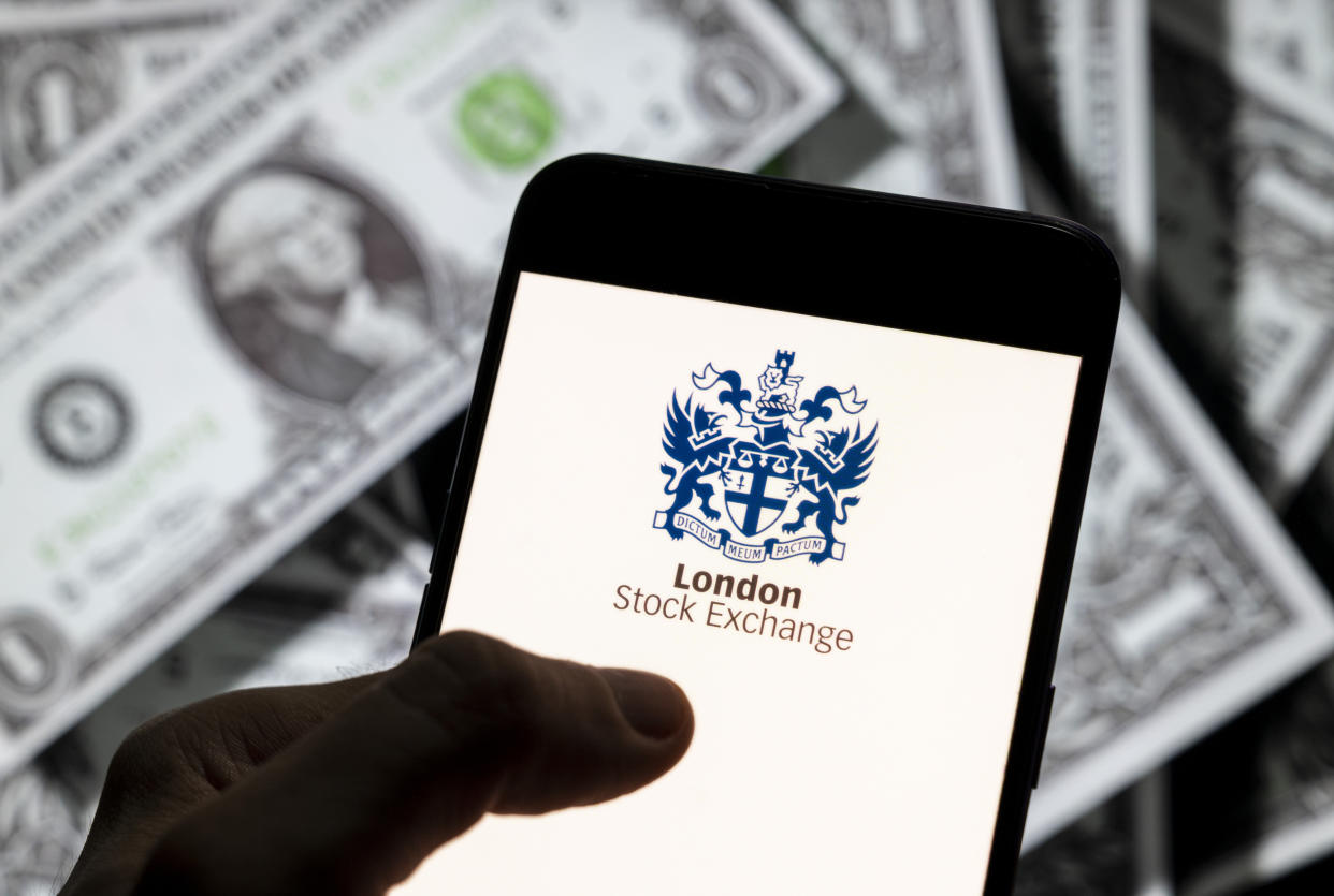 CHINA - 2021/04/14: In this photo illustration, the British London Stock Exchange index logo is seen on an Android mobile device screen with the currency of the United States dollar icon, $ icon symbol in the background. (Photo Illustration by Chukrut Budrul/SOPA Images/LightRocket via Getty Images)