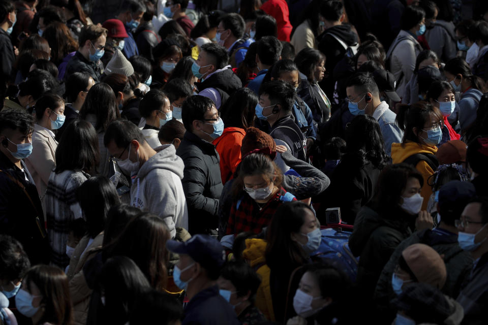 Visitors wearing face masks to help curb the spread of the coronavirus line up to enter an exhibition held at the Forbidden City in Beijing, Saturday, Nov. 7, 2020. China on Saturday reported 33 new confirmed coronavirus infections, all of which the National Health Commission said were in patients who contracted the virus abroad. (AP Photo/Andy Wong)