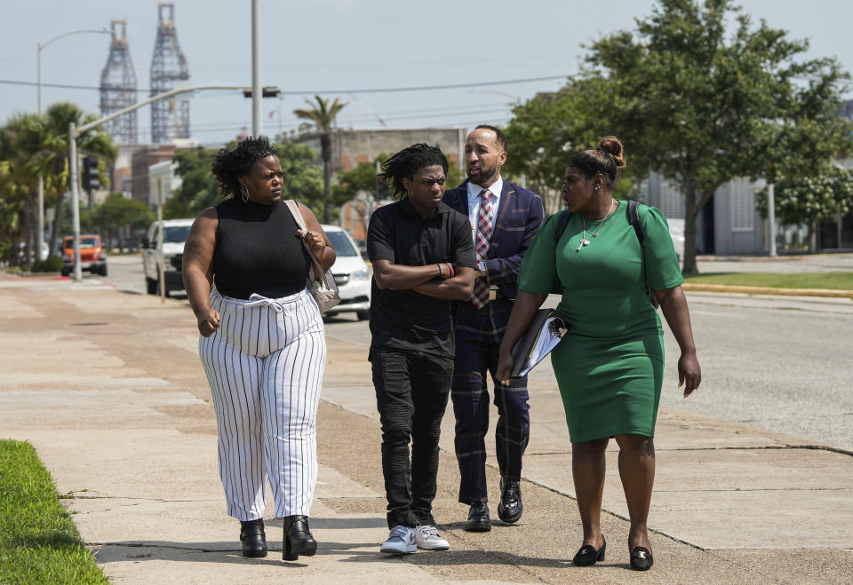 Darryl George, 18, walks out of Galveston County Court House next to his mother, Darresha George, attorney, Joseph Plumbar and his attorney Allie Booker on Thursday, May 23, 2024, in Galveston, Texas. A hearing was set to be held Thursday in a federal lawsuit a George filed against his Texas school district over his punishment for refusing to change his hairstyle. (Raquel Natalicchio/Houston Chronicle via AP)