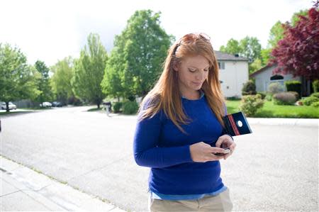 Stacey Barrack, hired by the Defending Main Street super PAC to get out the vote for Congressman Mike Simpson (R-ID), canvasses a neighborhood for the upcoming Republican primary election in Boise, Idaho May 10, 2014. REUTERS/Patrick Sweeney