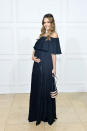 <p>The mom-to-be cradled her bump in an off-the-shoulder maxidress at Rachel Zoe's SS18 Presentation in West Hollywood, Calif.</p>