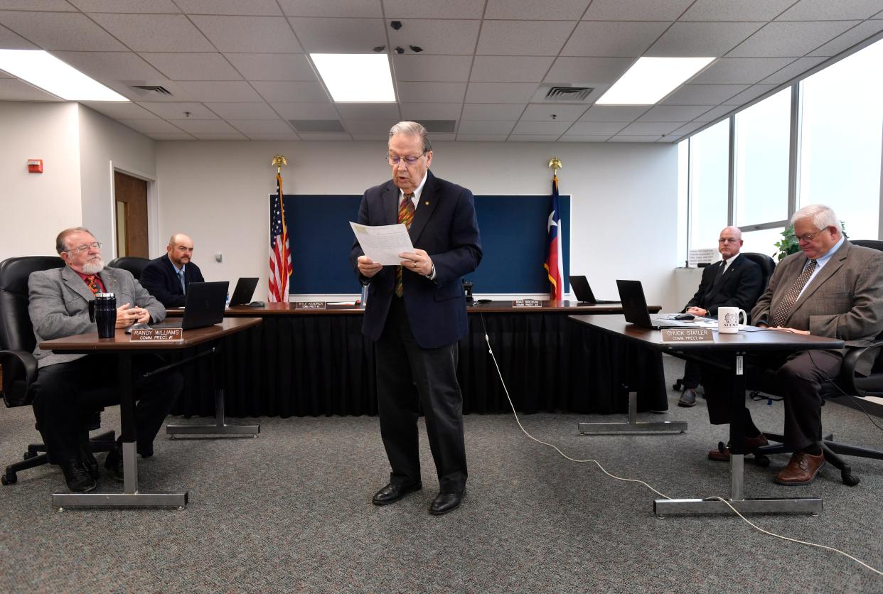 Taylor County Judge Downing Bolls reads a proclamation for an award during the Dec. 6 commissioners court meeting.