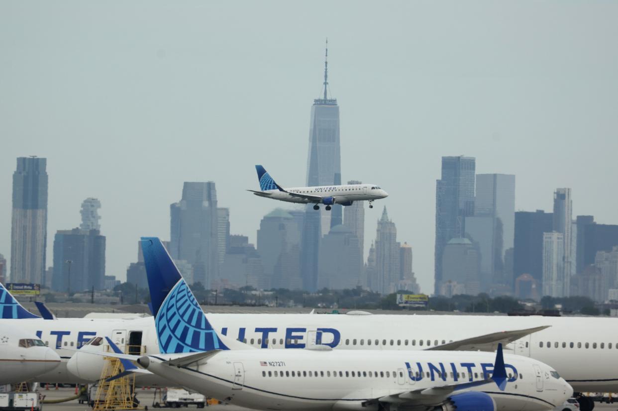 A United Airlines plane lands at Newark Liberty International Airport in front of the New York skyline on September 17, 2023 in Newark, New Jersey.