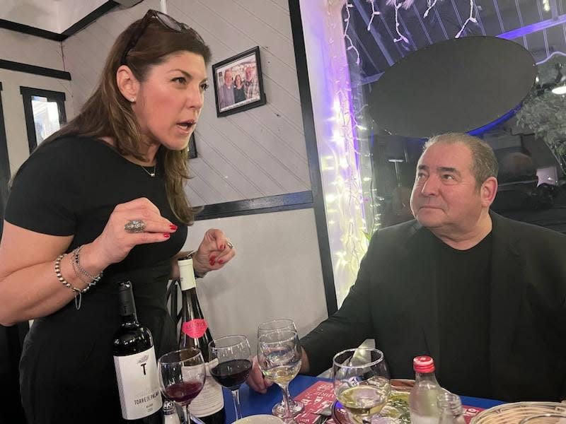 O Dinis' Natalia Paiva-Neves chats with Emeril Lagasse at his table at the East Providence Portuguese restaurant on Saturday night.