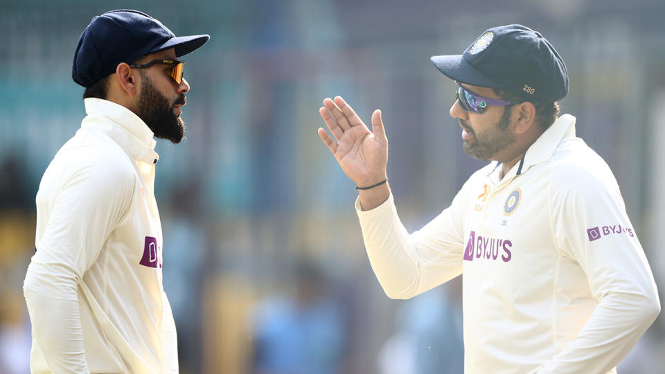 Virat Kohli and Rohit Sharma talk on the field.