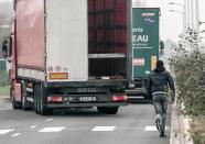 An illegal migrant tries to board a UK-bound truck in the northeastern French port of Calais