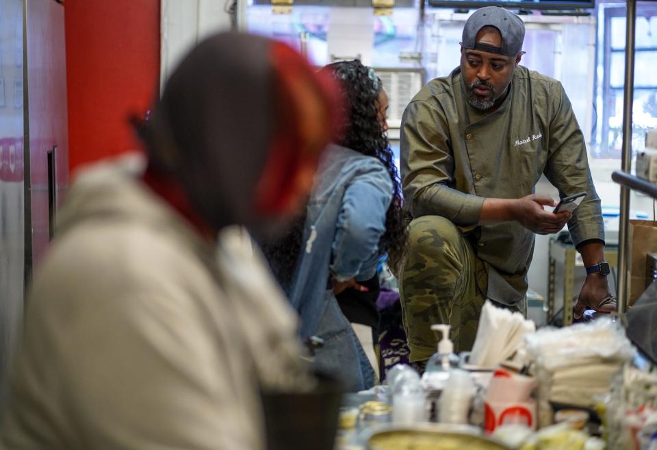 Jeds Detroit chef and owner Max Hardy, right, talks with manager L'Rae Howard while working to open his takeout business in Detroit on Feb. 22, 2021.