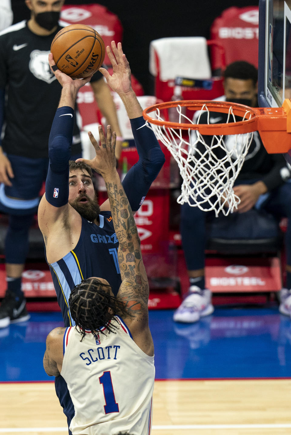 Memphis Grizzlies' Jonas Valanciunas, left, shoots over Philadelphia 76ers' Mike Scott during the second half of an NBA basketball game Sunday, April 4, 2021, in Philadelphia. The Grizzlies won 116-100. (AP Photo/Chris Szagola)