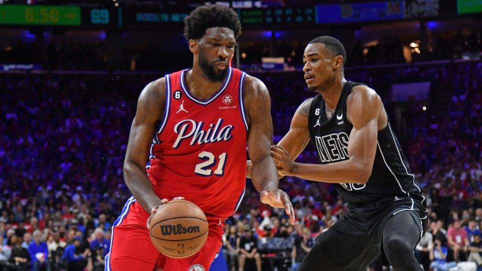 Apr 15, 2023;  Philadelphia, Pennsylvania, USA;  Philadelphia 76ers center Joel Embiid (21) drives to the basket against Brooklyn Nets center Nic Claxton (33) during the third quarter of game one of the 2023 NBA playoffs at Wells Fargo Center.