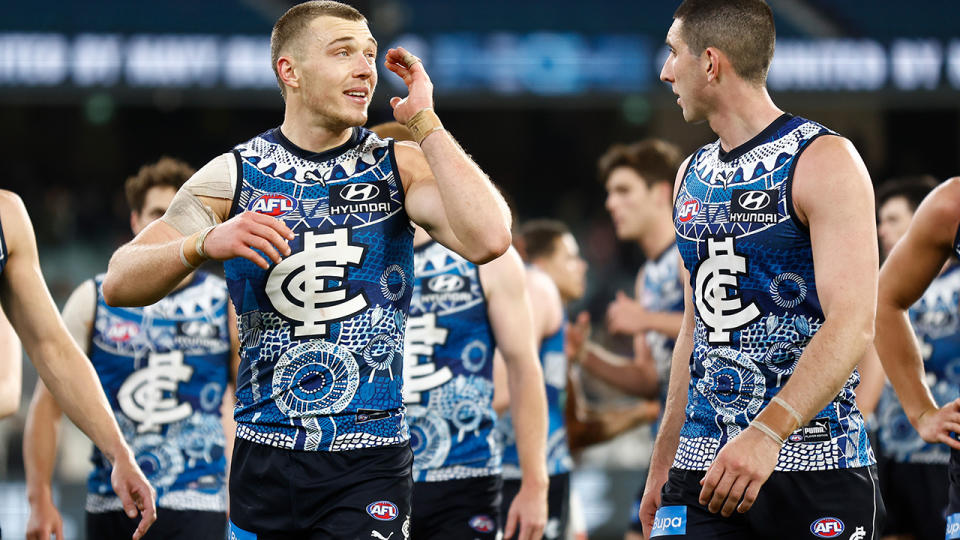 Carlton's Patrick Cripps and Jacob Weitering lead the team off the ground.