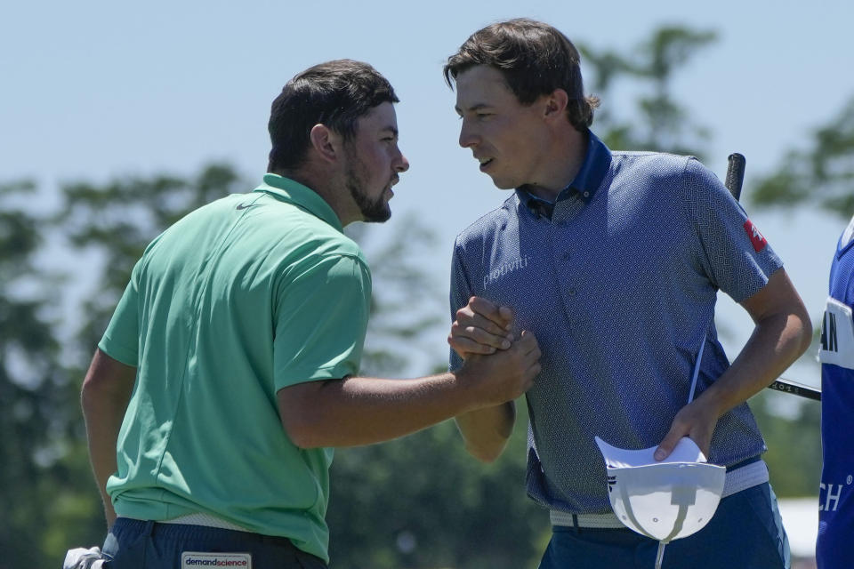 Matt Fitzpatrick, right greets his teammate and brother Alex Fitzpatrick, both of England, after they finished the day on the 18th green during the third round of the PGA Zurich Classic golf tournament at TPC Louisiana in Avondale, La., Saturday, April 22, 2023. (AP Photo/Gerald Herbert)