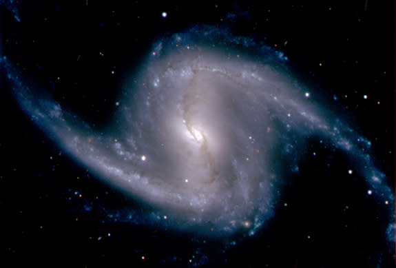 This photo from the new Dark Energy Camera, taken in September 2012, shows the barred spiral galaxy NGC 1365, in the Fornax cluster of galaxies, which lies about 60 million light years from Earth.