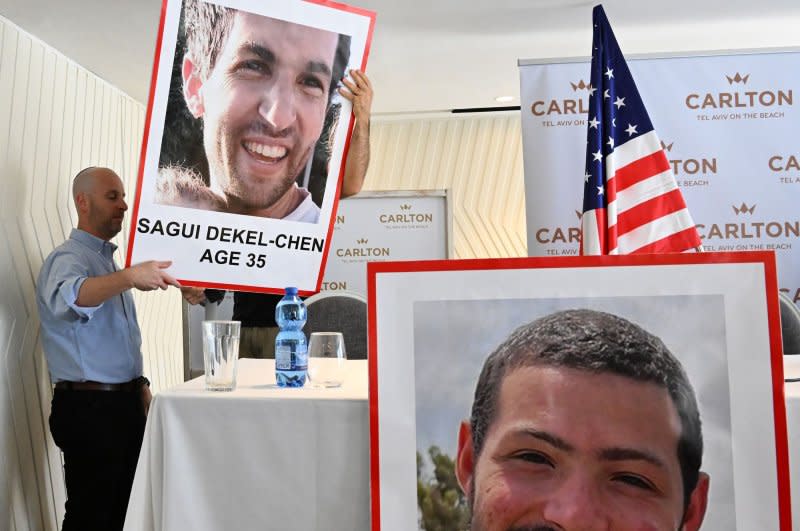 Photos of American-Israelis Sagui Dekel-Chen, 35, and Itay Chen, 19, who are missing and believed to be held hostage by Hamas in Gaza, are displayed Tuesday for a press conference in Tel Aviv, Israel. Photo by Debbie Hill/UPI
