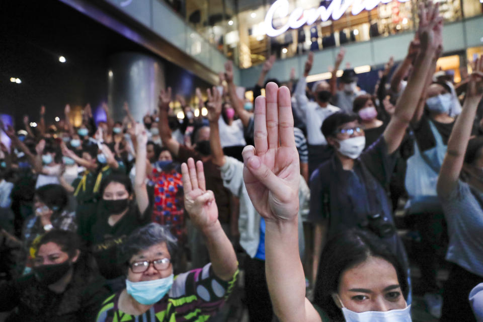 Pro-democracy demonstrators flash a three-finger salute of defiance during a protest rally at the Silom business district in Bangkok, Thailand, Thursday, Oct. 29, 2020. The protesters continue to gather Thursday with their three main demands of Prime Minister Prayuth Chan-ocha's resignation, changes to a constitution that was drafted under military rule and reforms to the constitutional monarchy. (AP Photo/Sakchai Lalit)