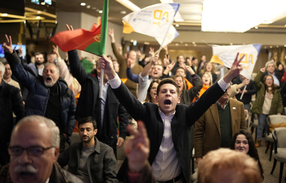 Supporters of center-right Democratic Alliance coalition party react after the announcement of the first results at their party headquarter in Lisbon, Sunday, March 10, 2024. Portugal is holding an early general election on Sunday when 10.8 million registered voters elect 230 lawmakers to the National Assembly, the country's Parliament. (AP Photo/Armando Franca)