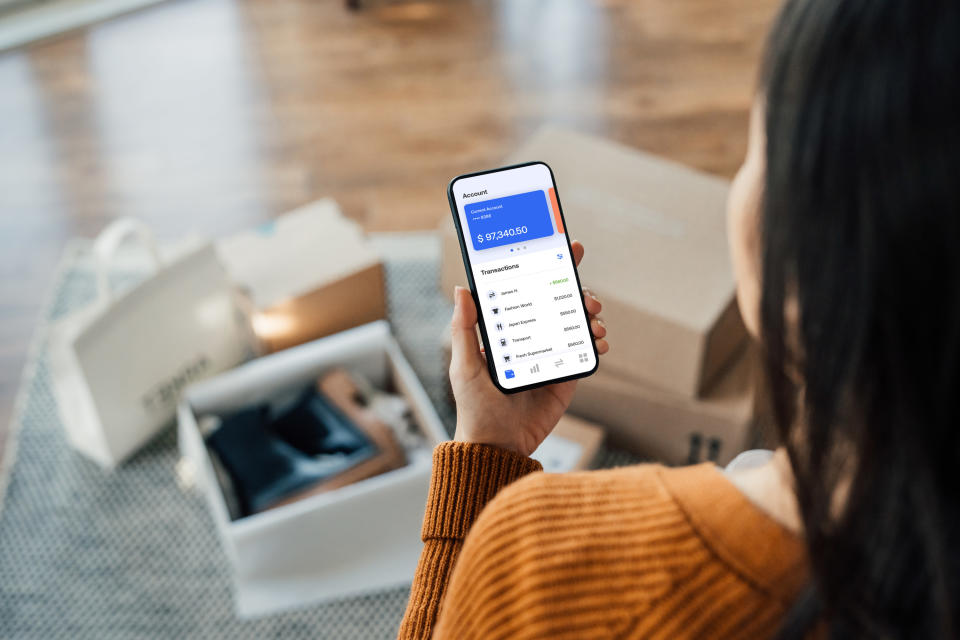 Woman looking at budgeting app on her phone