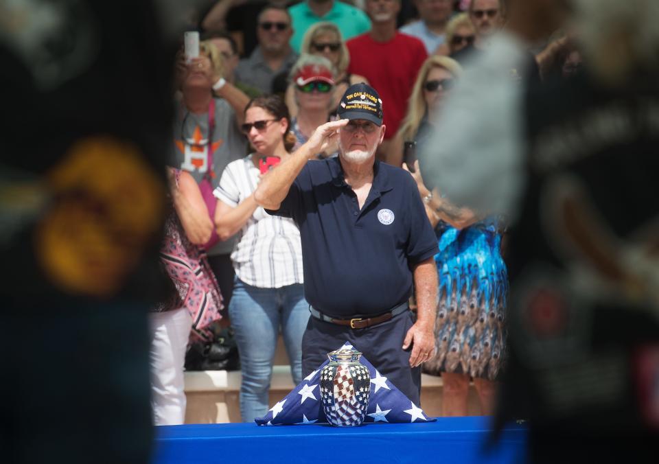 Jay Hatcher, a resident of Naples and a veteran accepts the flag for Naples resident Edward K. Pearson at the Sarasota National Ceremony. After a facebook post about Pearson went viral, thousand showed up for a memorial service honoring him. 