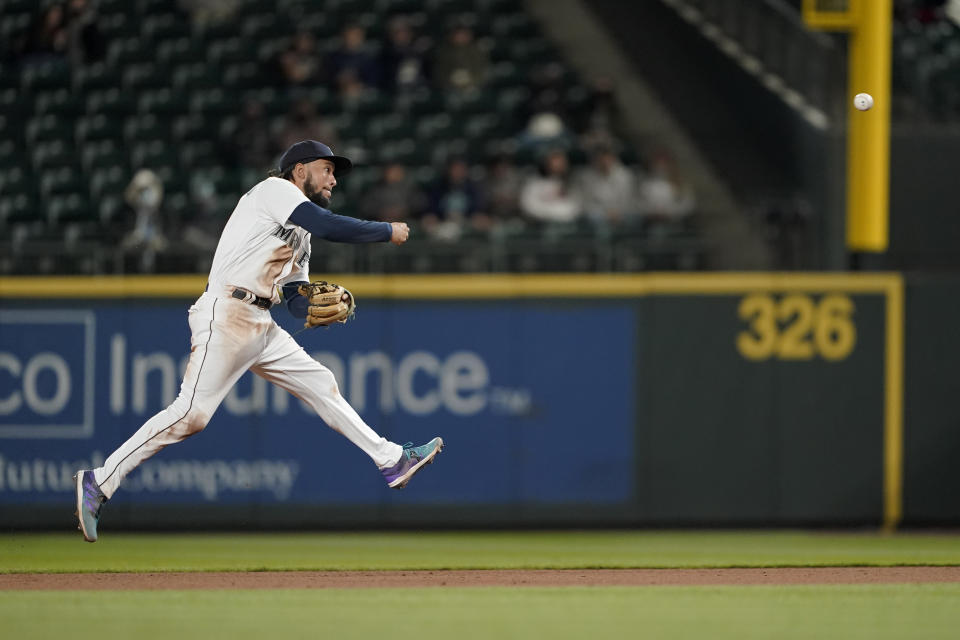 Seattle Mariners shortstop J.P. Crawford makes a leaping throw to get Baltimore Orioles' Chance Sisco out on a ground out play to first with the bases loaded to end the top of the sixth inning of a baseball game, Tuesday, May 4, 2021, in Seattle. (AP Photo/Ted S. Warren)