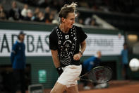 Sebastian Korda of the U.S. runs to the back of the court and return the ball through his legs during his third round match against Spain's Carlos Alcaraz at the French Open tennis tournament in Roland Garros stadium in Paris, France, Friday, May 27, 2022. (AP Photo/Thibault Camus)