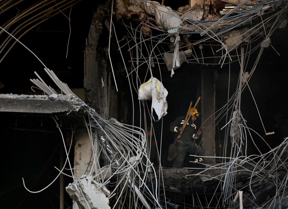 A worker clears debris in a destroyed building following Russian strikes in Kyiv on April 29, 2022, amid Russian invasion of Ukraine. - Russian strikes slammed into Kyiv on April 28, evening as UN Secretary-General Antonio Guterres was visiting.