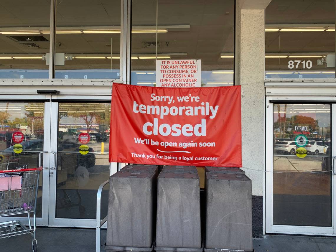 “We’ll be open again soon,” a red banner noting the temporary closing of a Winn-Dixie at 8710 SW 72nd St. in a Kendall-area strip mall waves at the front enrance on Feb. 20, 2023. But this store has been closed since July 2022 due to roof damage, parent company Southeastern Grocers said.