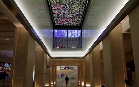 With a digital arcade ceiling above, a visitor walks down the entrance hall of the Museum of the Bible during a preview day in Washington - Credit: Reuters