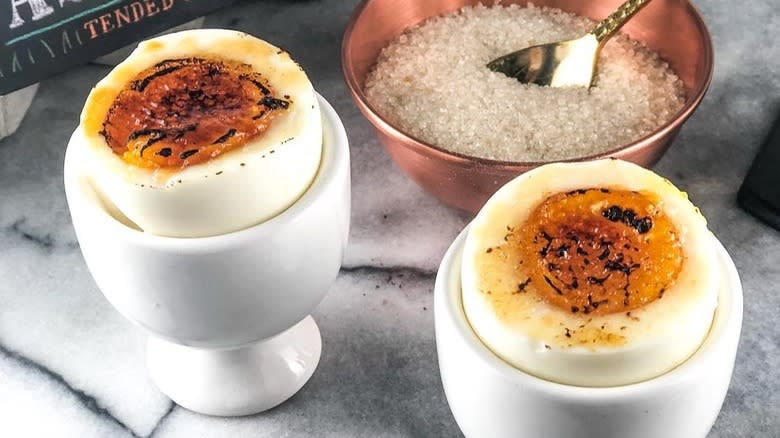 Seared eggs in white egg cups