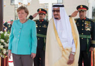 Saudi Arabia's King Salman bin Abdulaziz Al Saud stands next to German Chancellor Angela Merkel during a reception ceremony in Jeddah, Saudi Arabia April 30, 2017. Bandar Algaloud/Courtesy of Saudi Royal Court/Handout via REUTERS