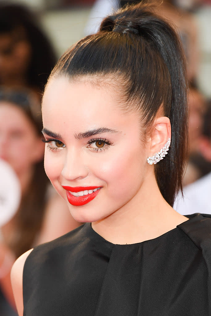 <p>The key to working a bold lip? Keeping the rest of your makeup look simple, as shown by up-and-coming singer Sofa Carson, who paired her bright red lipstick with minimal eye makeup and a slicked back high ponytail. <i>(Photo by George Pimentel/WireImage)</i><br></p>