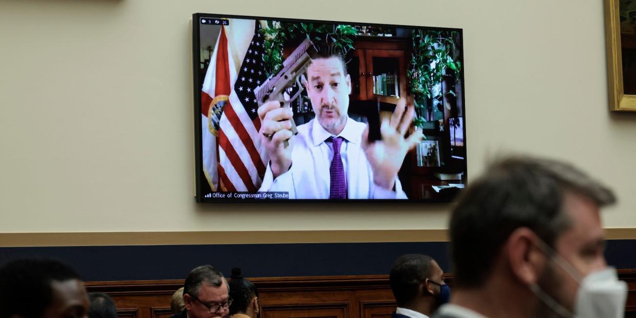 Republican Rep. Greg Steube of Florida displays his handgun while Zooming into a House Judiciary Committee mark up hearing on gun legislation on June 2, 2022.