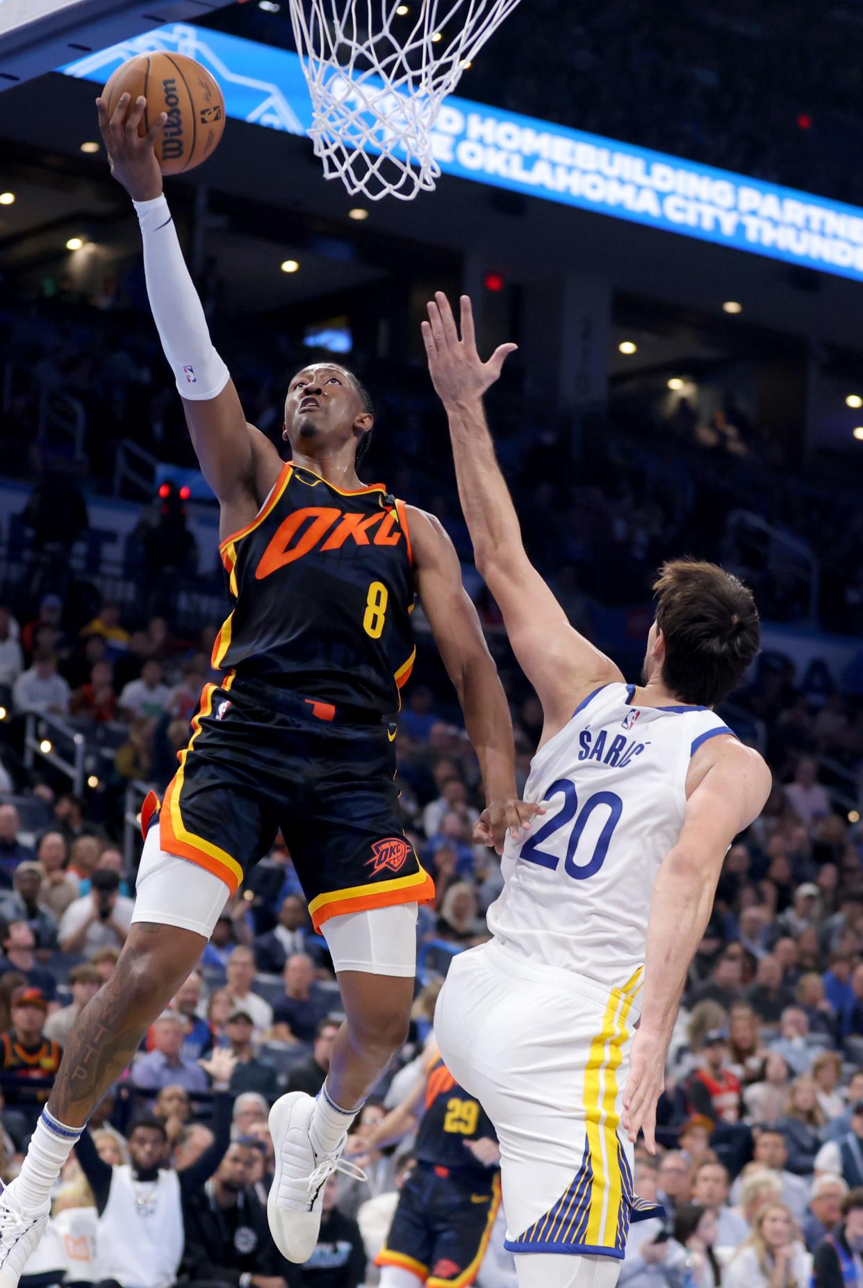 Oklahoma City Thunder forward Jalen Williams (8) goes up for a lay up as Golden State Warriors forward Dario Saric (20) defends in the second half of the NBA basketball game between the Oklahoma City Thunder and the Golden State Warriors at Paycom Center in Oklahoma City, Friday, Nov., 3, 2023.