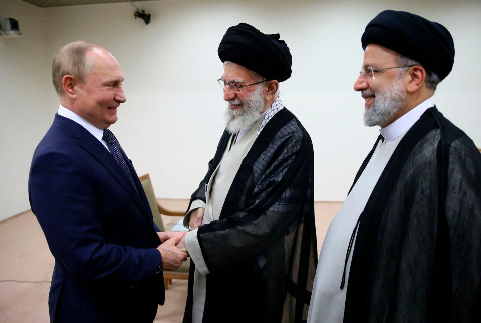 Iran’s Supreme Leader Ayatollah Ali Khamenei and Vladimir Putin, left, greet each other as Iranian President Ebrahim Raisi stands at right (Office of the Iranian Supreme Leader via AP)